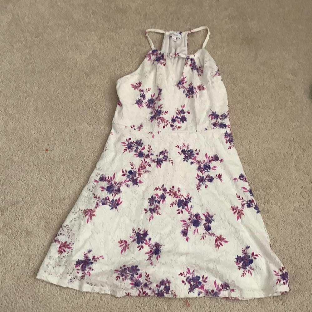 White little girls dress with floral print. Slit near the chest area.